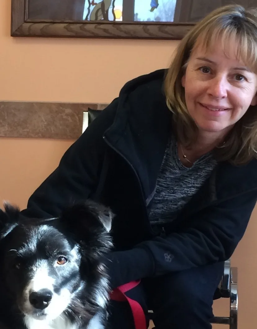 Anne, bookkeeper at Three Islands Veterinary Services, with Bandit the dog